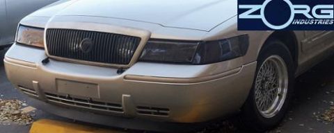 2000 Mercury Grand Marquis - Front view of a gold 2000 Mercury Grand Marquis, showing its distinctive grille and headlights, with a Zorg Industries logo visible.
