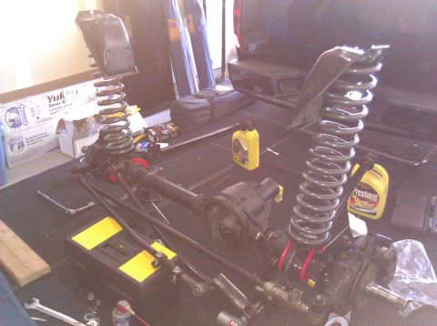 1995 Ford Bronco - Front axle and suspension parts laid out, possibly for a Ford Bronco build.