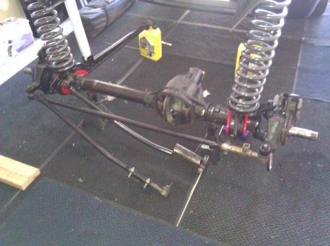 1995 Ford Bronco - Front axle assembly with coil springs and shocks, likely for an off-road vehicle modification.
