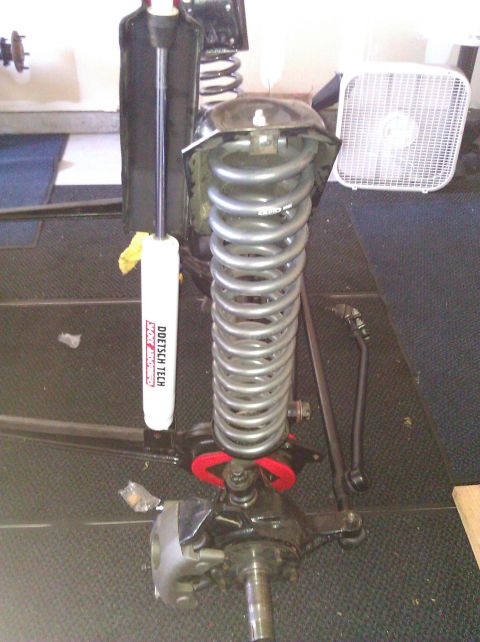 1995 Ford Bronco - Front suspension assembly a coil spring and a Doetsch Tech shock absorber, likely for an off-road vehicle.