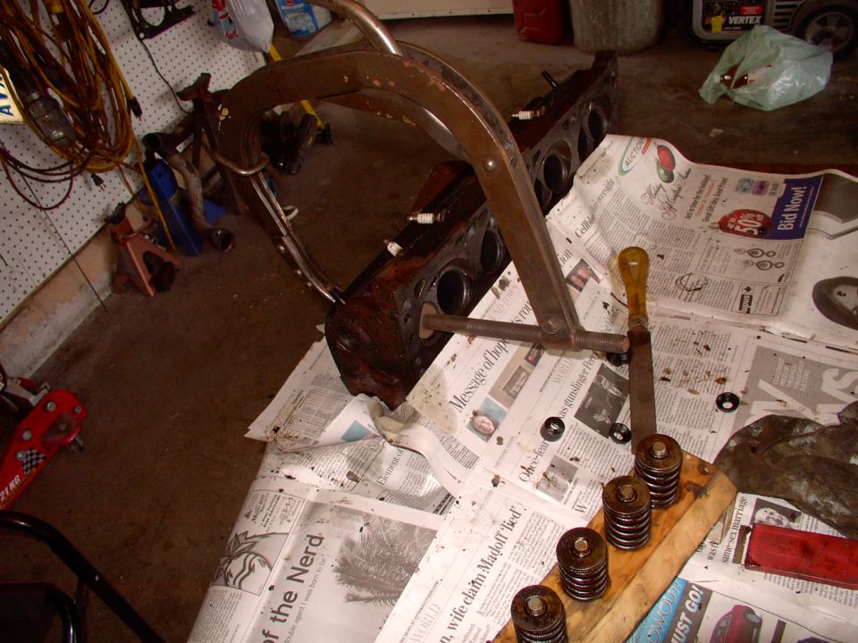 Borrowed a buddy's valve spring compressor for an hour and disassembled the heads. Great shape, but the seals were so brittle they cracked up as we removed them