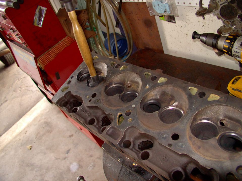 If hand lapping the valve seats and faces doesn't work, then you're in for a fairly hefty machine shop bill.