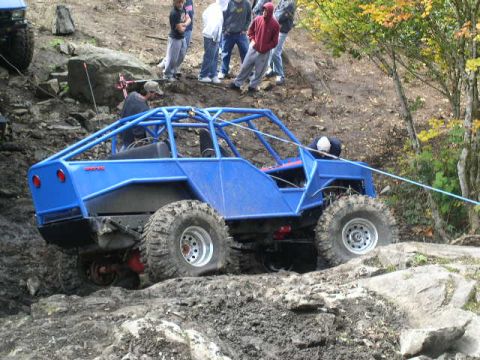1979 Ford Bronco - A custom-built buggy navigates a challenging off-road course with onlookers present.