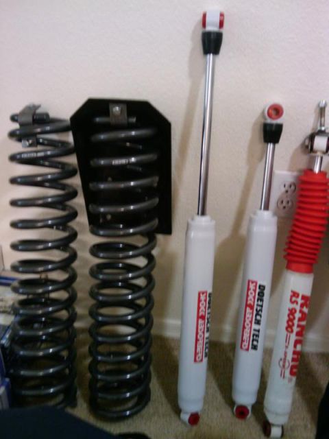 1995 Ford Bronco - Various suspension components, including coil springs and shock absorbers, are displayed against a wall.