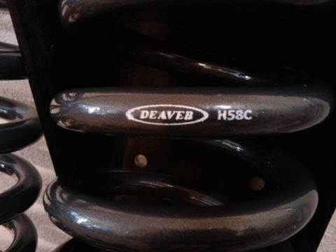 1995 Ford Bronco - A close-up view of a Deaver H58C coil spring, part of a suspension system.