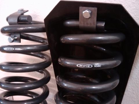 1995 Ford Bronco - Close-up of Deaver HSBC suspension springs, one mounted on a black bracket.