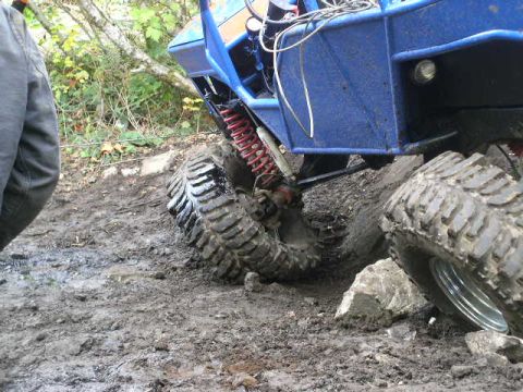 1979 Ford Bronco - This off-road vehicle navigates challenging muddy terrain, its robust tires and suspension system.