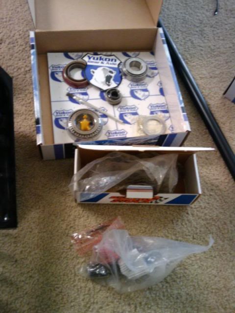1995 Ford Bronco - Yukon Gear & Axle parts, including bearings and seals, are laid out in opened boxes.