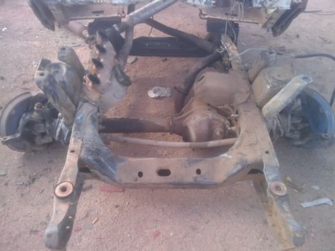 1995 Ford Bronco - This is a close-up view of a vehicle's chassis and suspension system, showing various metal components.