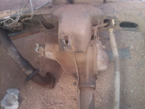 1995 Ford Bronco - The underside of a vehicle shows the rear axle, differential, and exhaust system components.