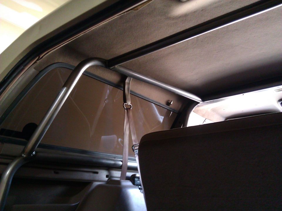 Interior view of a vehicle's roll cage and seatbelt
