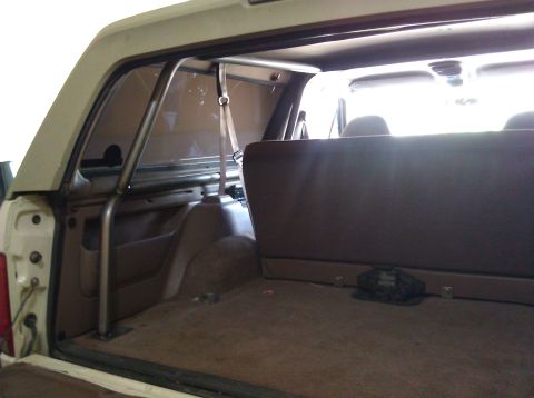 1995 Ford Bronco - The interior of a 1992 Ford Bronco shows a custom roll cage installed behind the seats.