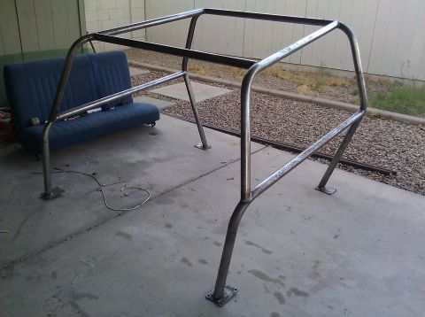 1995 Ford Bronco - Custom roll cage assembly with a blue seat visible behind it.