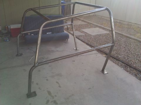 1995 Ford Bronco - A custom-built metal roll cage is shown outdoors, resting on a concrete surface.