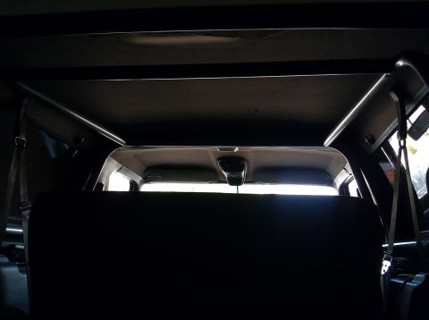 1995 Ford Bronco - The photo shows the interior of a vehicle, focusing on the roll cage and rear seating area.