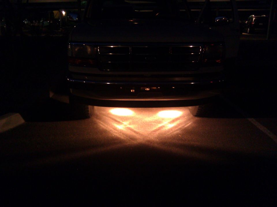 truck front end, grille, and headlights at night