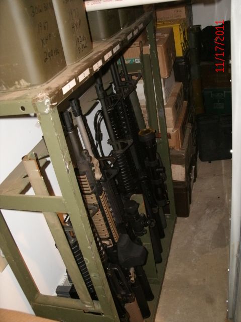 2000 Ford Crown Victoria - A rack holds several rifles, with storage containers and boxes visible in the background. The date 11/17/2011 is visible on the right.