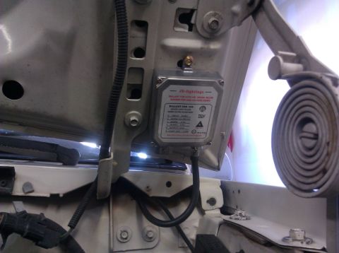 1995 Ford Bronco - A ballast for HID Xenon light bulbs is visible, mounted under the hood of a vehicle.