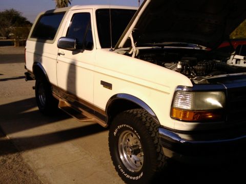 1995 Ford Bronco - This 1995 Ford Bronco is shown in a 3/4 front view with its hood open, revealing the engine compartment.