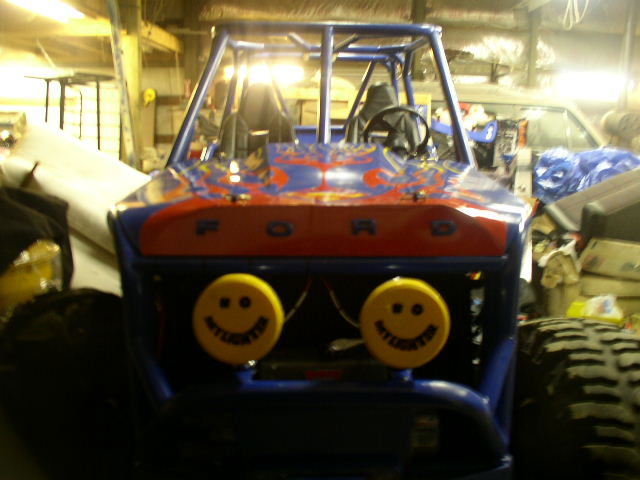 Blue buggy with red "FORD" lettering and two yellow smiley face lights