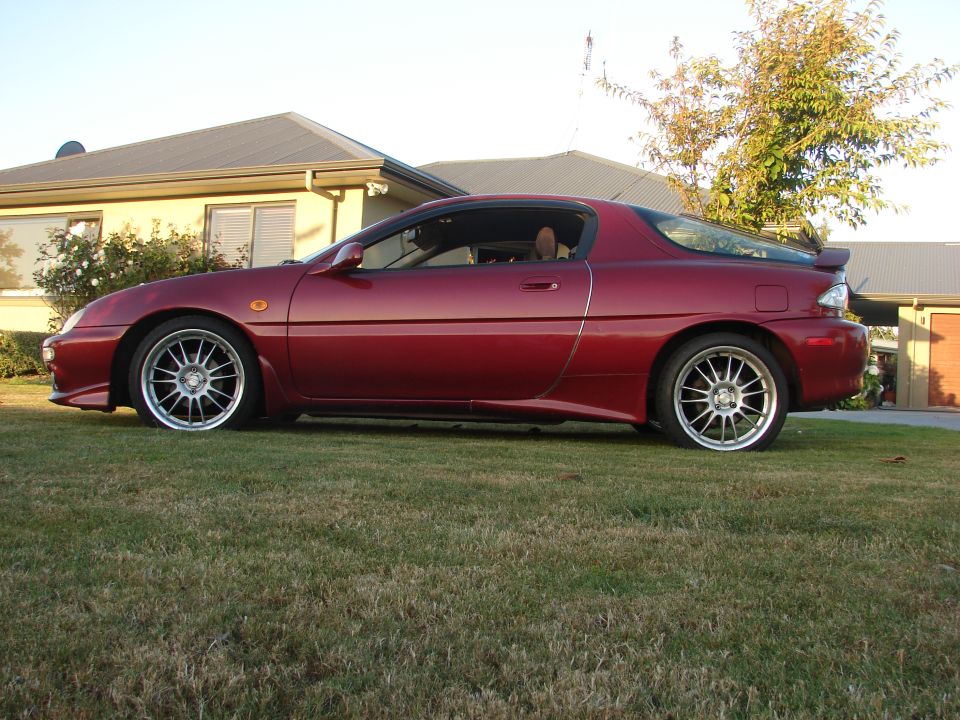 Red 1993 Mazda MX-3 coupe, side view