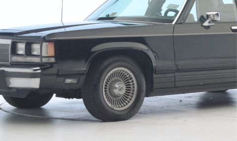 1971 Ford Ranchero - Close-up of a 1991 Ford Crown Victoria's front passenger side, showing the fender and wheel.