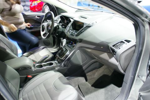 1993 Ford Taurus - Interior view of a modern car, with a woman getting into the driver's seat.