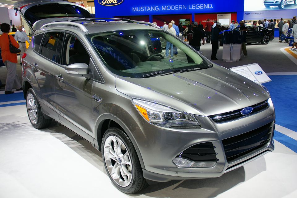 Silver Ford Escape on display at an auto show, with its trunk open