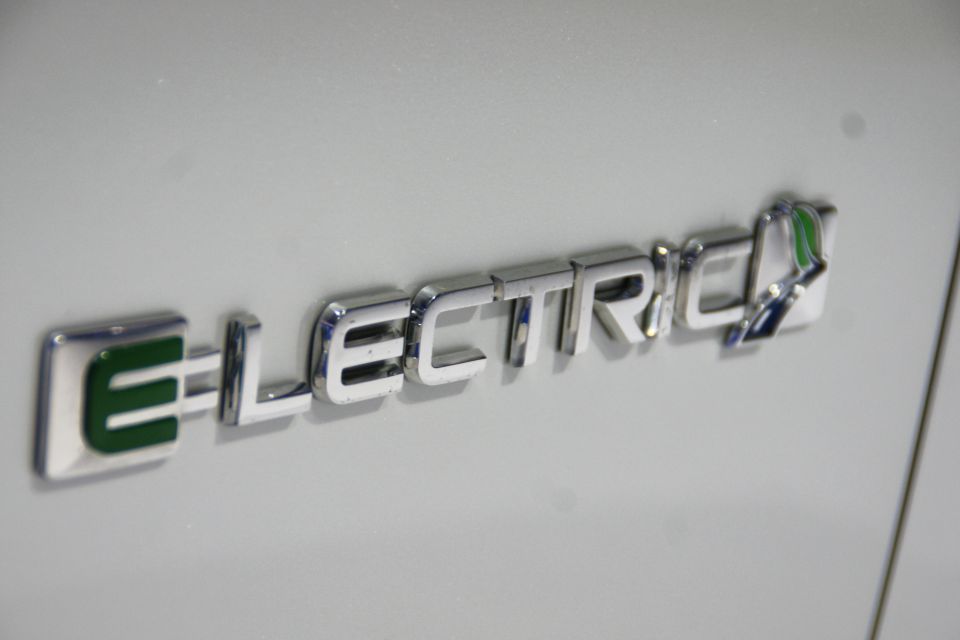 Chrome badge with green E and text ELECTRIC