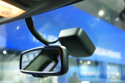 1993 Ford Taurus - Close-up of a car's interior showing the rear-view mirror and a sensor unit.