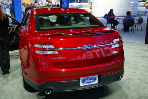 1993 Ford Taurus - Red Ford Taurus at an auto show, rear view.