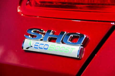 1993 Ford Taurus - The rear of a red vehicle displays the SHO and EcoBoost badging.