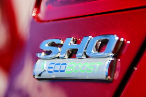 1993 Ford Taurus - Close-up of a red car's rear emblem showing "SHO EcoBoost".
