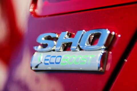 1993 Ford Taurus - Close-up of a red car's SHO EcoBoost badge.