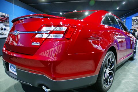1993 Ford Taurus - Rear view of a red Ford sedan at an auto show.