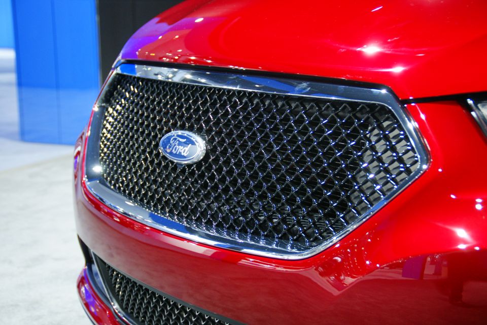 Red Ford Taurus with chrome grille and Ford logo