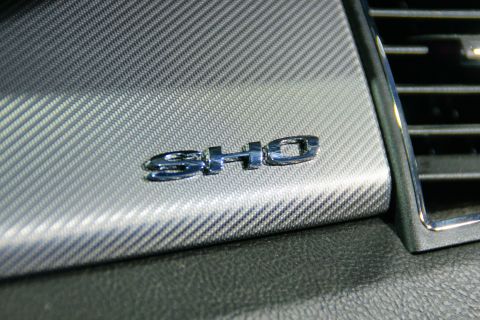 1993 Ford Taurus - The SHO badge is visible on the dashboard of a vehicle, set against a textured background.