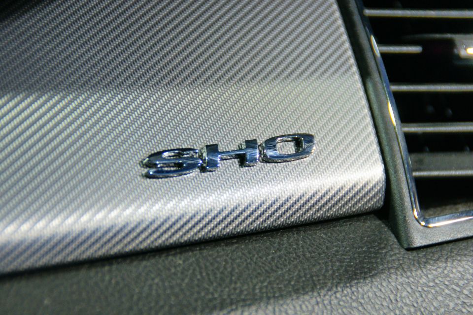 Close-up of SHO badge on a carbon fiber-patterned dashboard