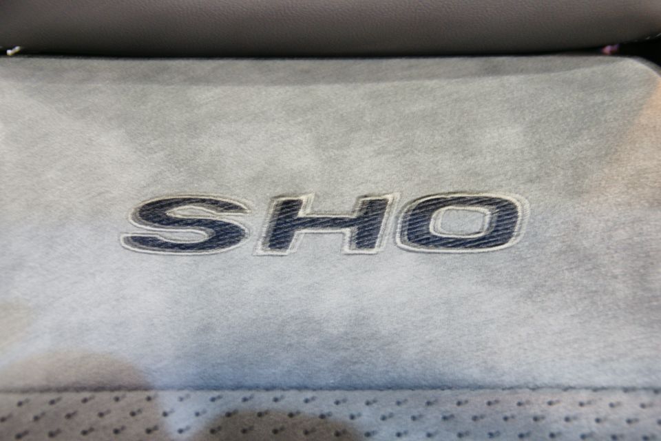 Embroidered SHO emblem on a gray car seat