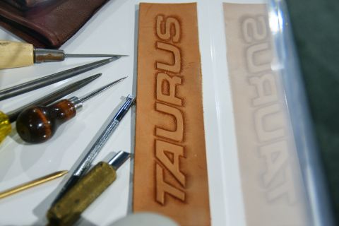 1993 Ford Taurus - Leather tooling supplies and a strip embossed with the word TAURUS.