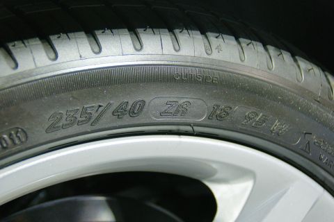 1993 Ford Taurus - The tire sidewall displays its size and load index, indicating it is an 18-inch wheel with a 235/40 aspect ratio.