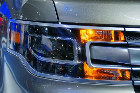 1993 Ford Taurus - The intricate design of a modern car's headlight and turn signal is captured in this close-up shot.