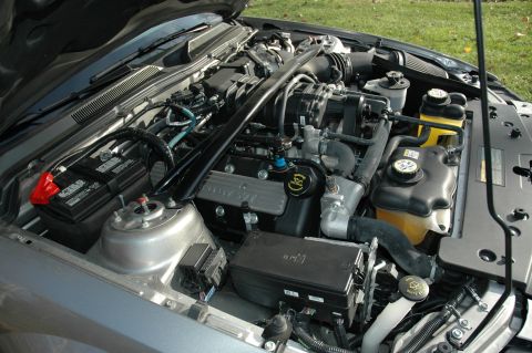 2008 Ford Mustang - The engine bay of a 2008 Ford Mustang Shelby GT500 is visible with the hood open, revealing the supercharged V8 engine and associated compo…