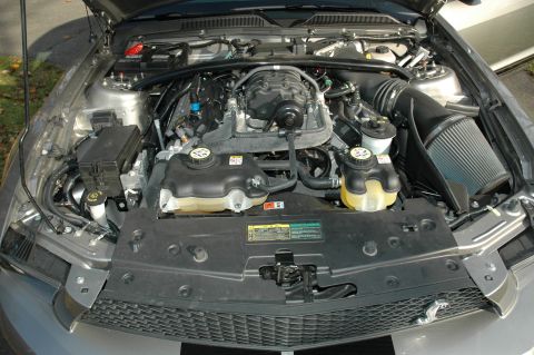2008 Ford Mustang - Engine bay of a silver Ford Mustang, showing the engine and various components.