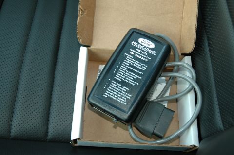 2008 Ford Mustang - Ford Racing Pro-Cal calibration tool, part number CM-12685-A100, shown in its box on perforated leather car seats.