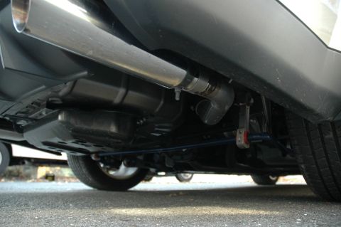 2008 Ford Mustang - Close-up view of the underside of a vehicle, focusing on the exhaust pipe and suspension.