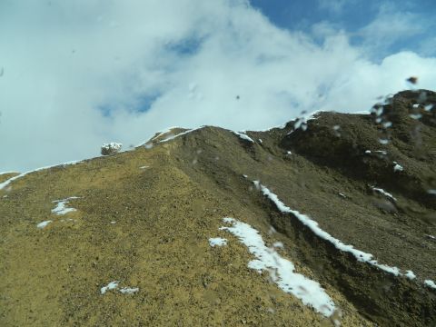 1979 Ford Bronco - Mountain landscape with snow under a cloudy sky. Water droplets on the lens.