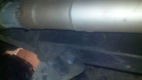 1988 Ford Bronco - Close-up shot of the undercarriage, focusing on the frame and exhaust system components.