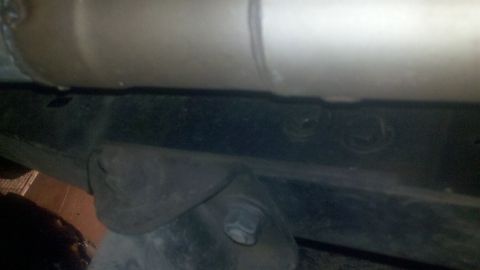 1988 Ford Bronco - Close-up view of the undercarriage, showing the vehicle's chassis and exhaust system components.