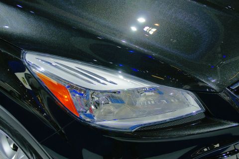 1993 Ford Taurus - The intricate design of a modern vehicle's headlight is captured in this close-up shot.